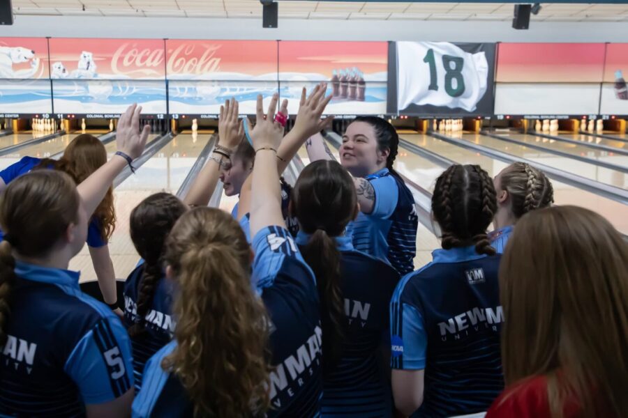2024-25 Newman women's bowling team celebrates during a tournament in Wichita