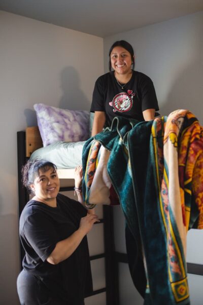 Ana sits atop her bunk bed in Carrocci Hall.