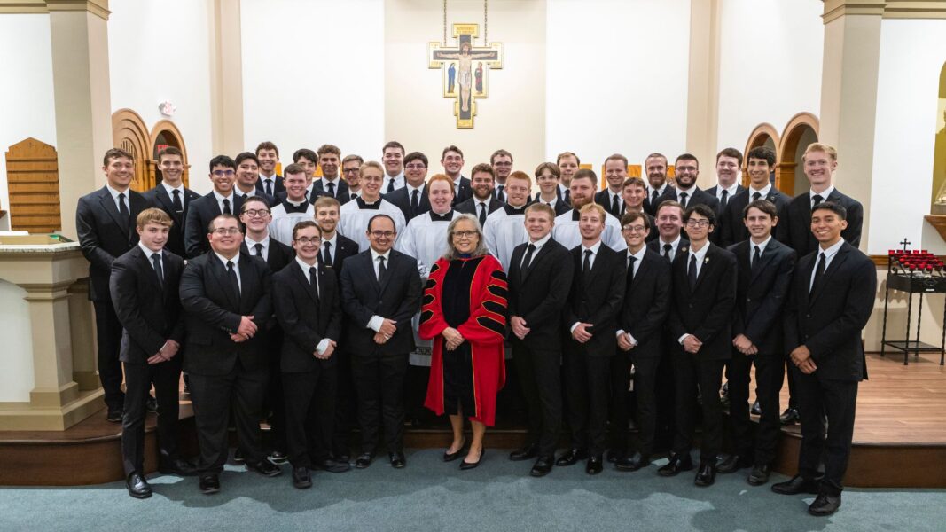 President Kathleen S. Jagger, Ph.D., MPH, (center) with seminarians who are current students at Newman University.