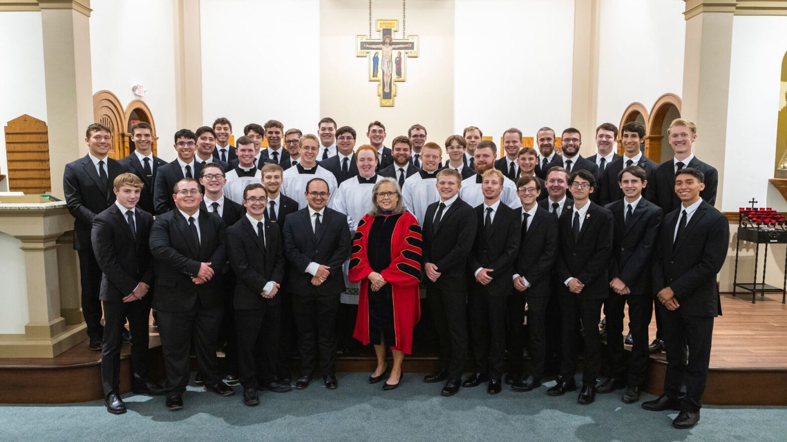 President Kathleen S. Jagger, Ph.D., MPH, (center) with seminarians who are current students at Newman University.