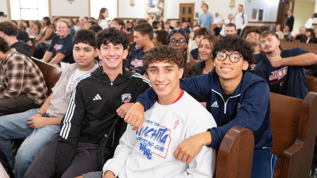 First-year students smile in the pews of St. John's Chapel.