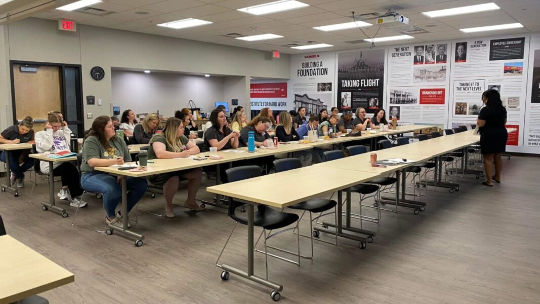 Rials addresses students in a classroom.