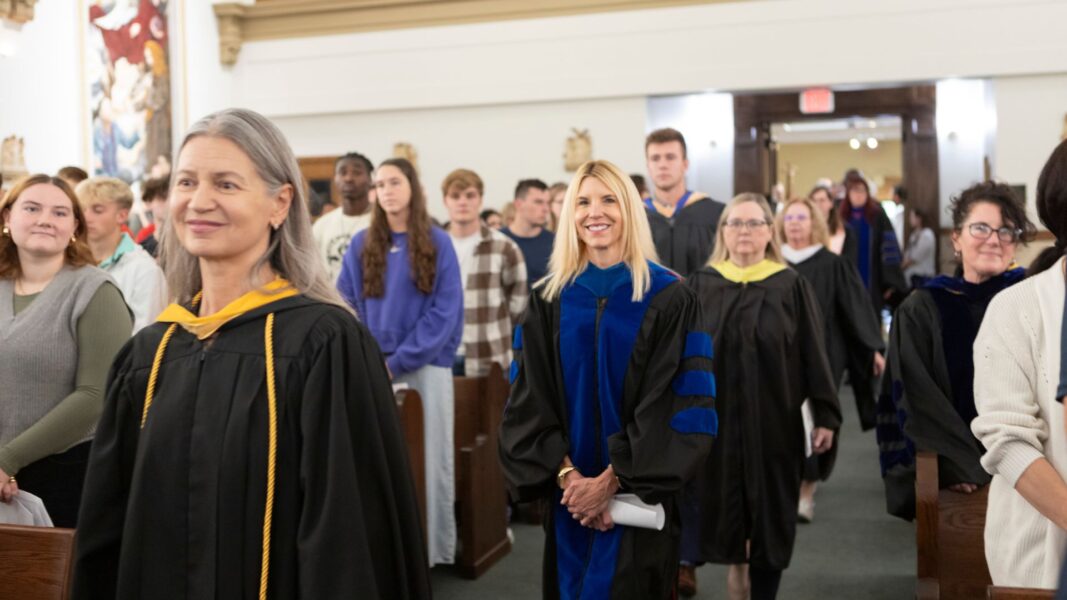 Newman faculty process into St. John's Chapel.