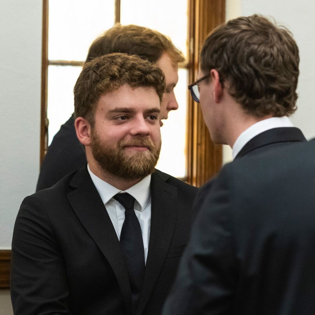 Seminarians offer "peace be with you" during Mass.