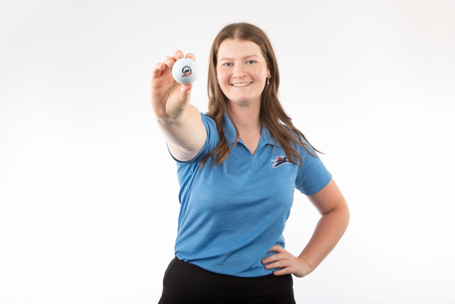 Griffiths holds up a Newman Jets golf ball.