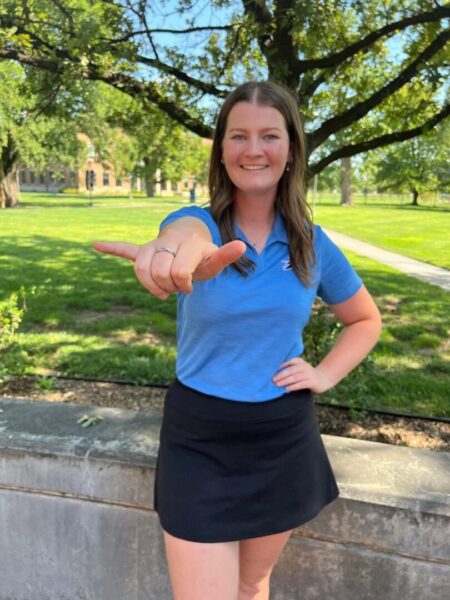 Griffiths shows off the Newman Jet sign on campus.