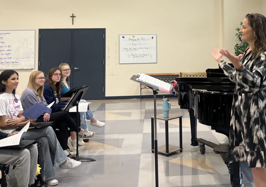 Pictures Swords directing students during Choral rehearsal