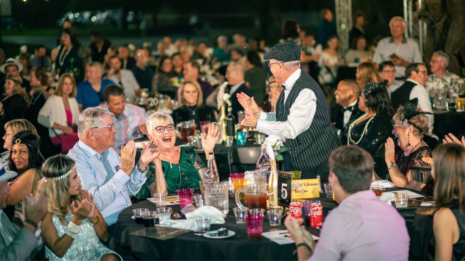 The crowd at Party on the Plaza 2024 cheers during the live auction portion of the evening.