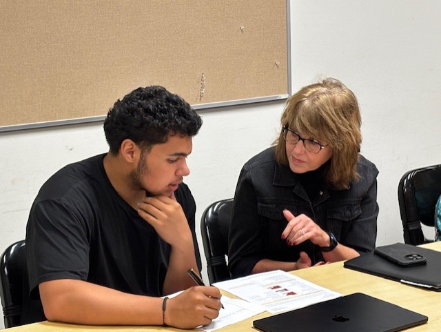 Students collaborate over data about strengths and needs during a Flight Planning class.