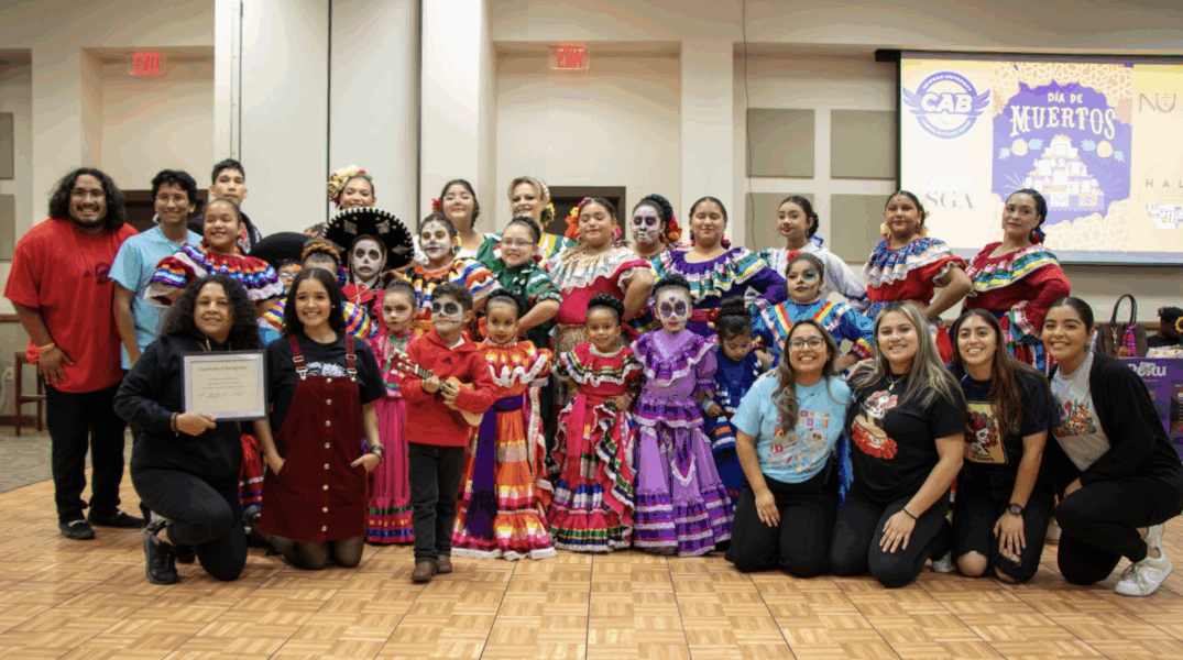Rodriguez pictured in group with other members of HALO and Día de los Muertos dancers