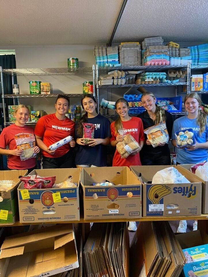 Pictures Newman soccer players posing with food panty food