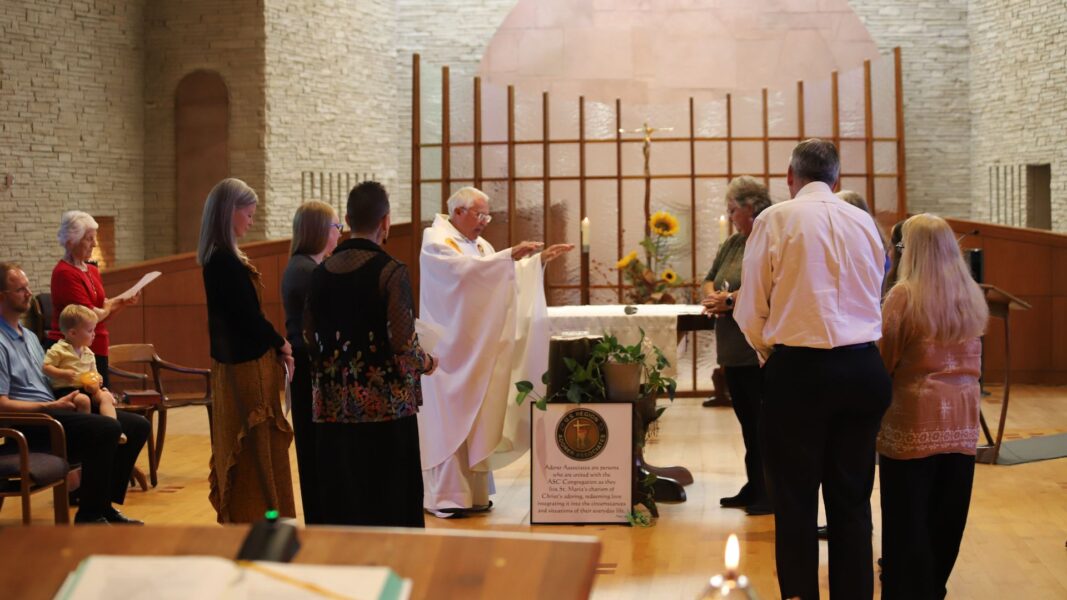 The Rev. Tom Welk gives a blessing over the pins.