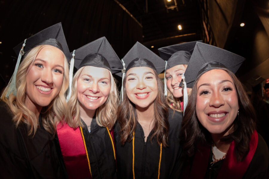 Pictures Puentes Probedo with other other graduates in graduation gowns and caps
