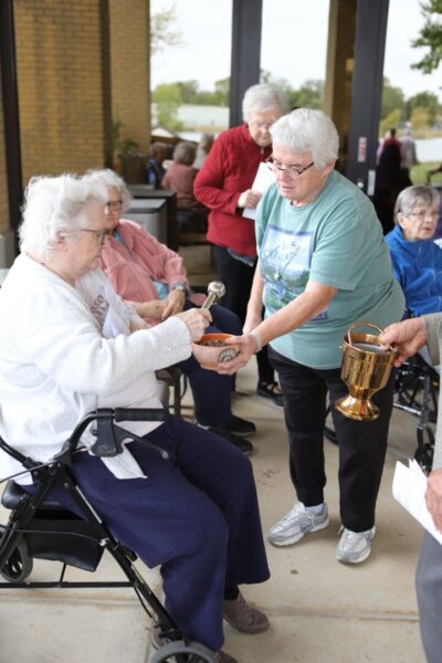 Pictures sisters doing anointing with oil at Vespers service