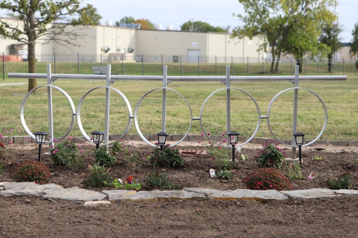Pictures the five metal cylinders lined up in the garden
