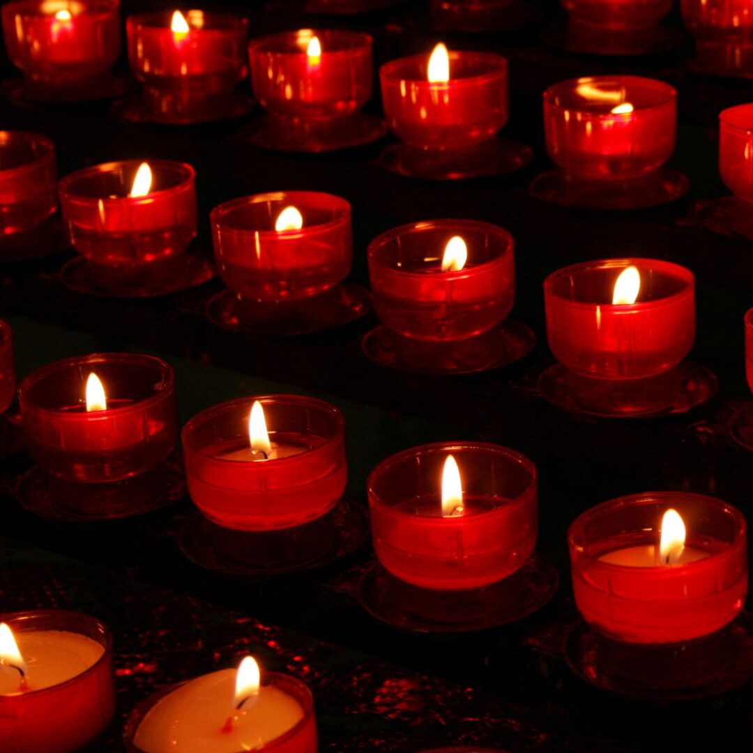 Red candles pictured in a chapel