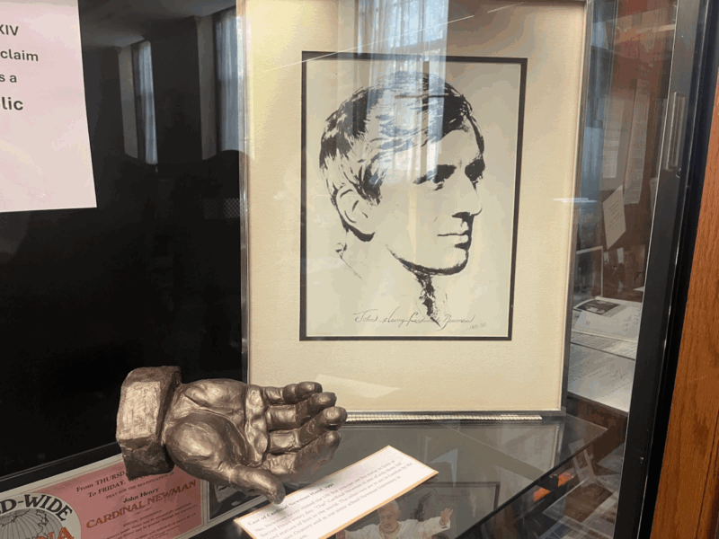 Shows St. Newman drawing and model cast of his hand in the display