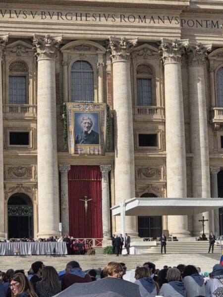 St. Newman's picture appears on the side of St. Peter's Basilica during a special audience with the pope for conference-goers.