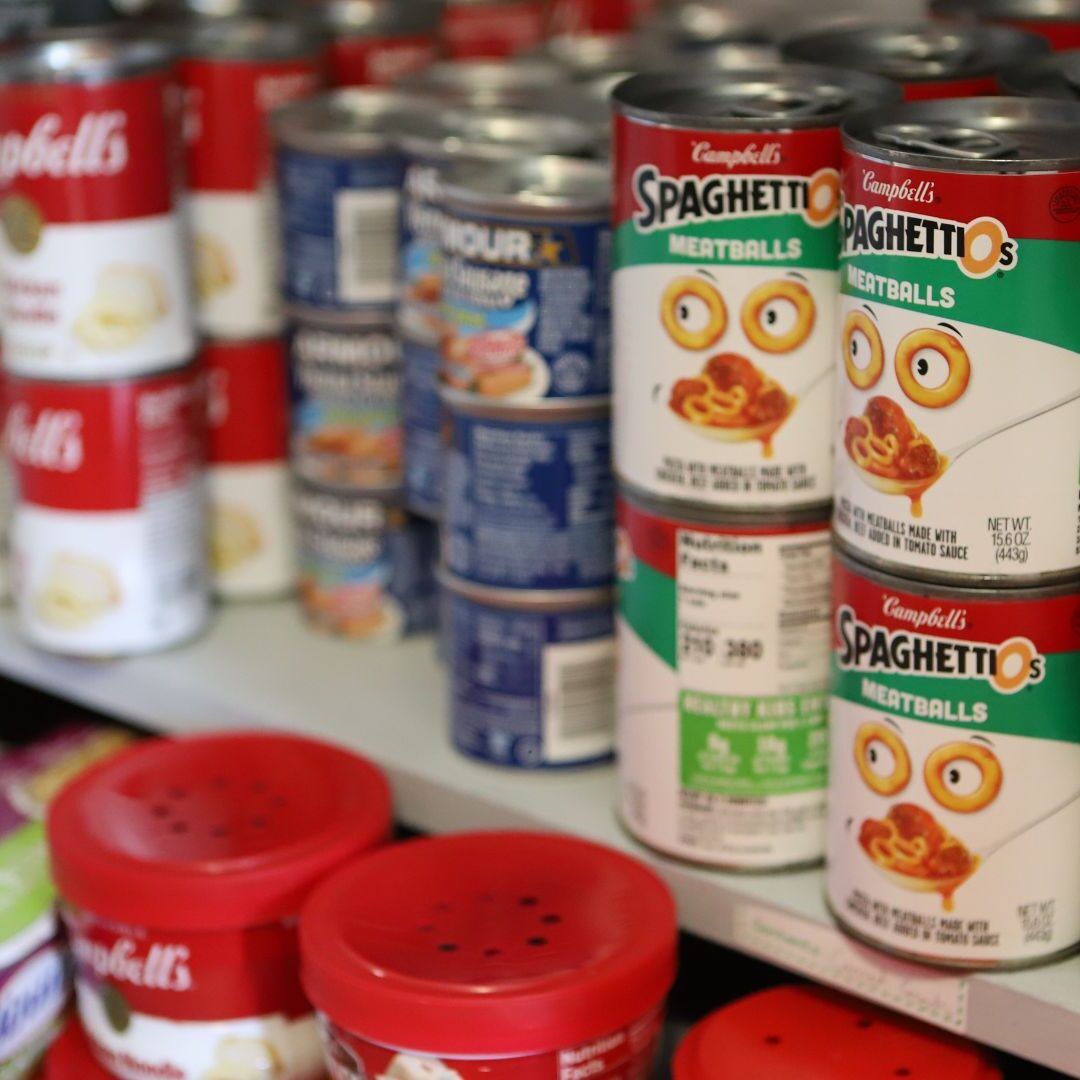Canned goods line the shelves of the Jets Resource Hub.