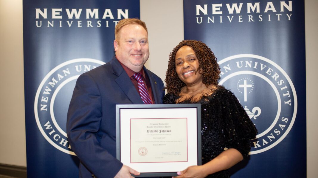 Stout awards Johnson with the 2025 Faculty Excellence Award.