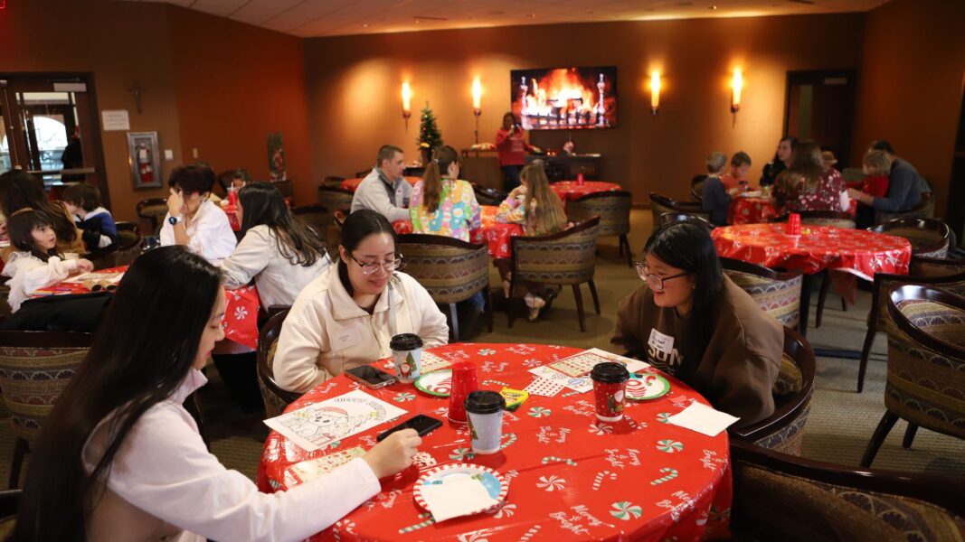 Guests fill the holiday-themed Sister Tarcisia Roths, ASC, Alumni Center at Newman University.