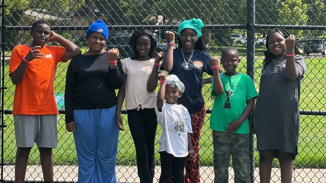 Students smile and show off their wristbands from Bahati's event.