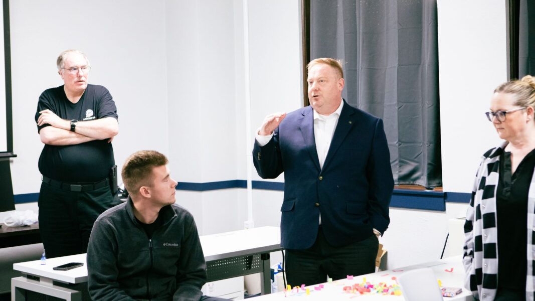 Stout addresses the J1 implementation team.