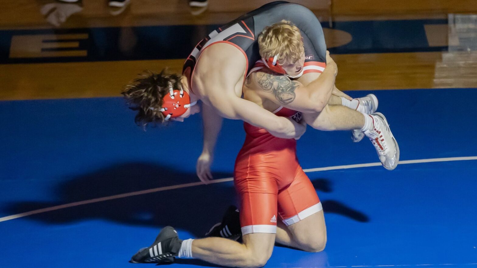 Newman men's wrestler (in red)