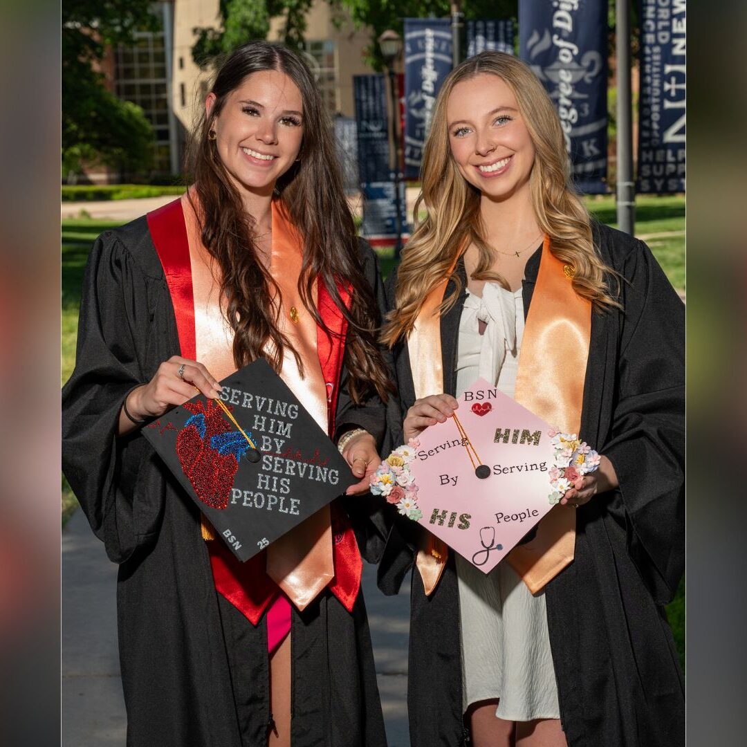 Schaefer (left) poses for a graduation picture with a friend.