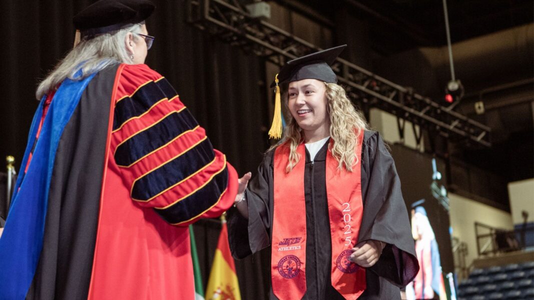 Johnson walks across the stage at graduation