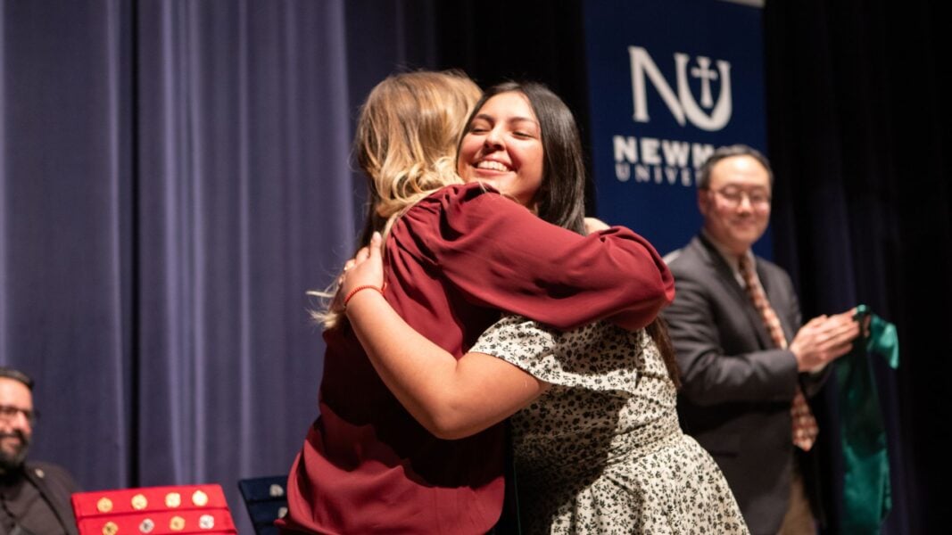A graduate hugs Director of the Respiratory Care Program Stacie Fox during the School of Healthcare Professions pinning ceremony.