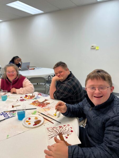 Three "Fall into Art" guests painting fall trees