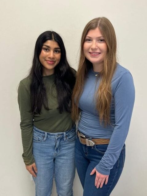 Ahmed and Adams posing together at capstone event