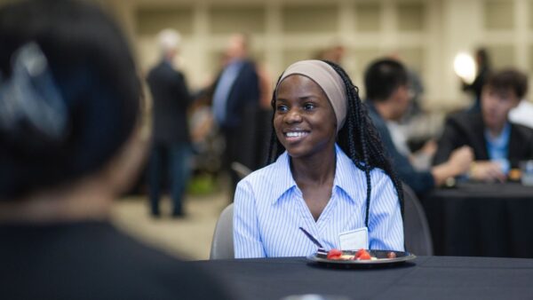 A student attends a School of Business & Technology mixer in fall 2026.
