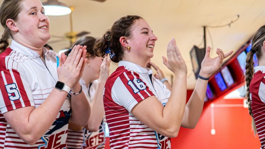 Bowlers Kaylin Wahlmeier and Tallie Scott applaud their team during the Bel-Air Bowl in Belleville, Illinois. (Courtesy photo: GLVC)