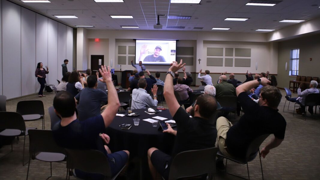 Attendees of a real-world AI applications event listen to guest speaker Dallin Bentley.