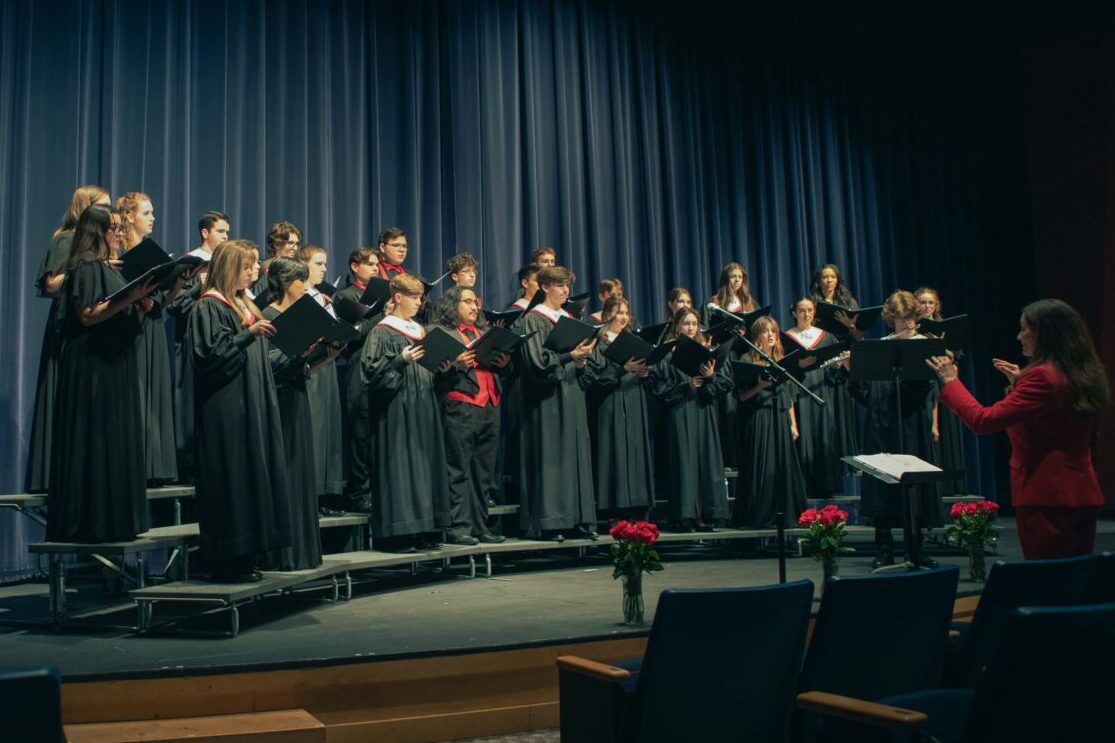 All choirs singing together on stage