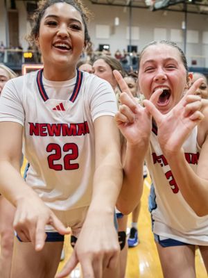 Newman Jets celebrate their basketball win on homecoming night.