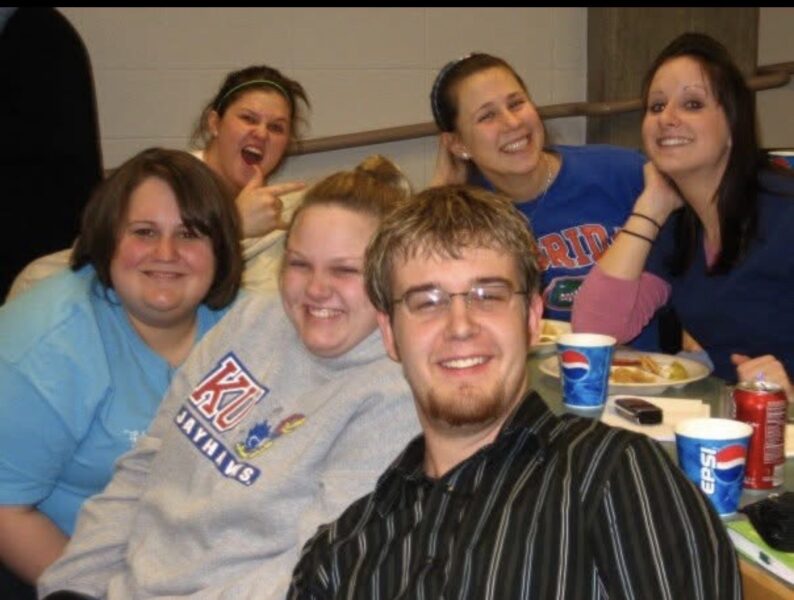 Walker (grey sweatshirt) with fellow students at Newman University