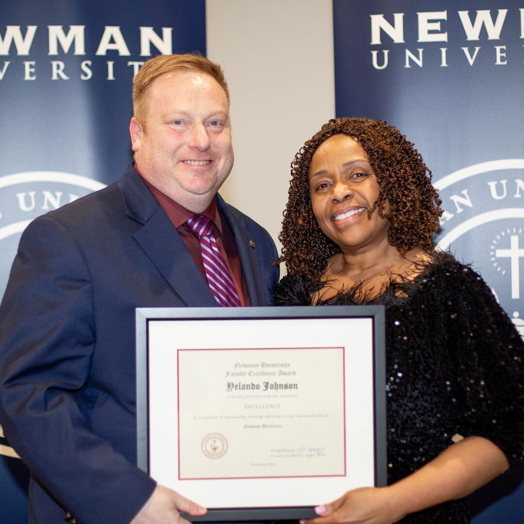 Stout awards Johnson with the 2025 Faculty Excellence Award.