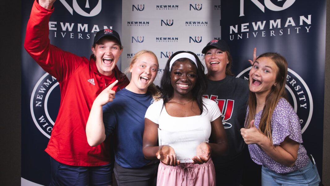 Smith (center) is celebrated by her softball coach and teammates for winning the Sister Vivian Miller Award.
