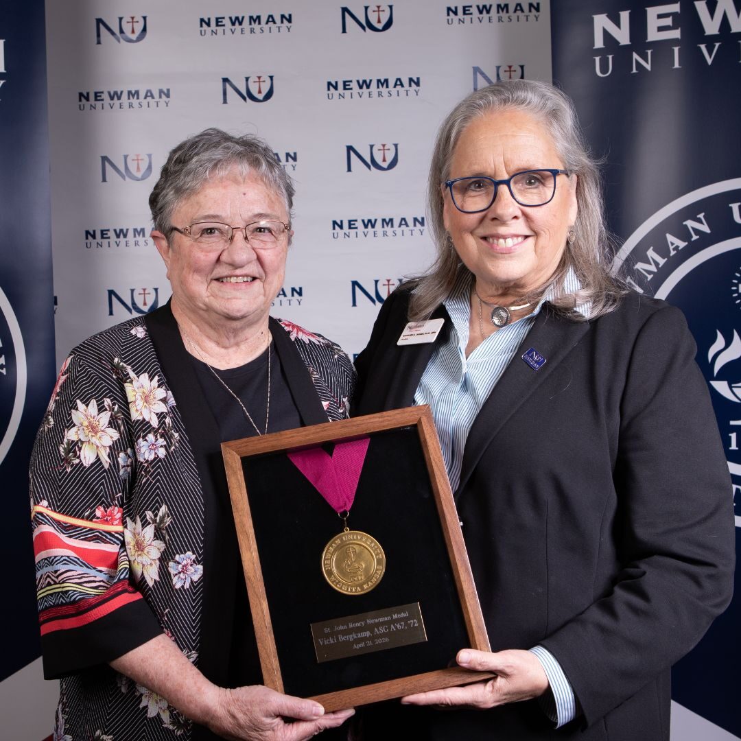 Bergkamp (left) was awarded the St. Newman Medal by President Jagger.