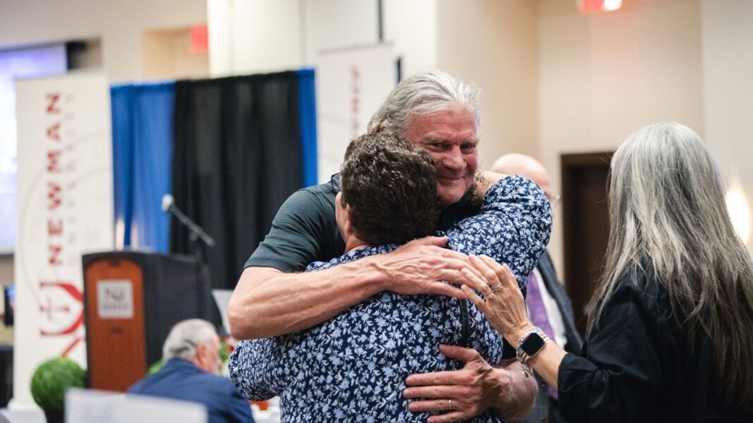 Guests embrace at the 2026 Legacy Awards Banquet.