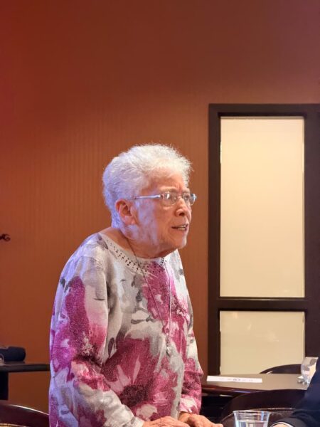 Roths addresses the room of Pi Gamma Mu inductees.