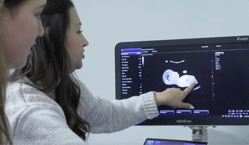 Led by program director Brooke Ward, Newman students look at an ultrasound in the diagnostic sonography program.