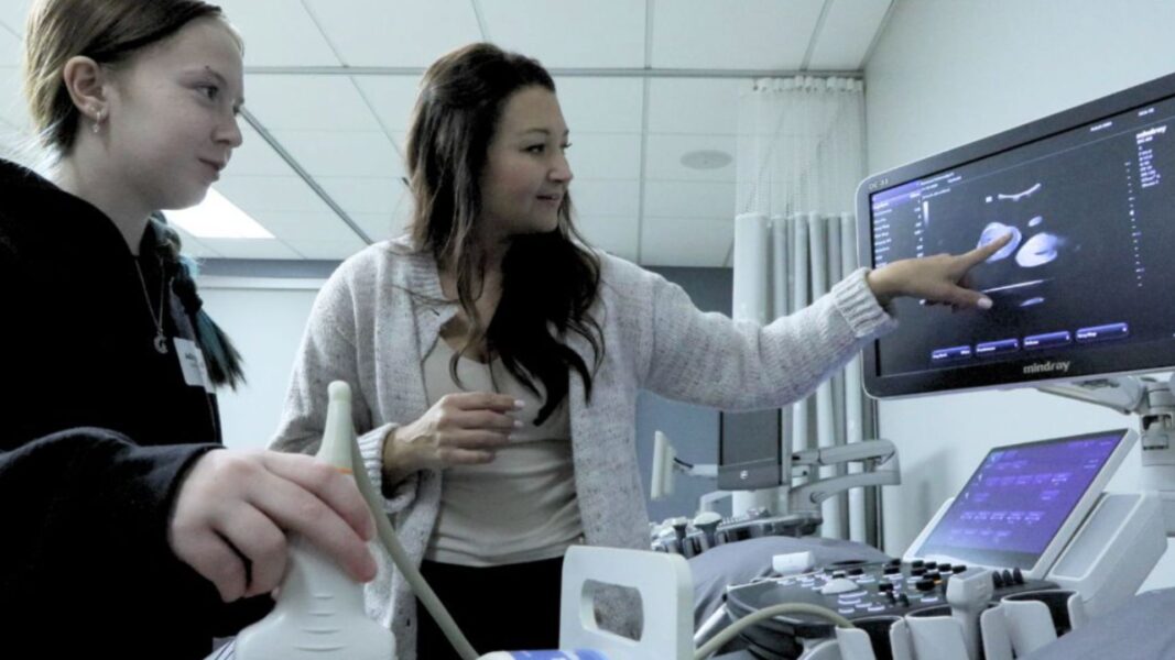 Ward demonstrates how to use ultrasound equipment during a Newman heathcare professions information session.