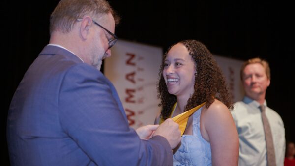 Radiologic Technology graduate Adrian Walker receives her ceremonial pin.