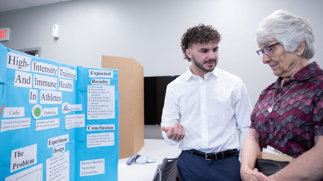 Bartlett shares his research with Sister Therese Wetta, ASC, during Scholars Day.