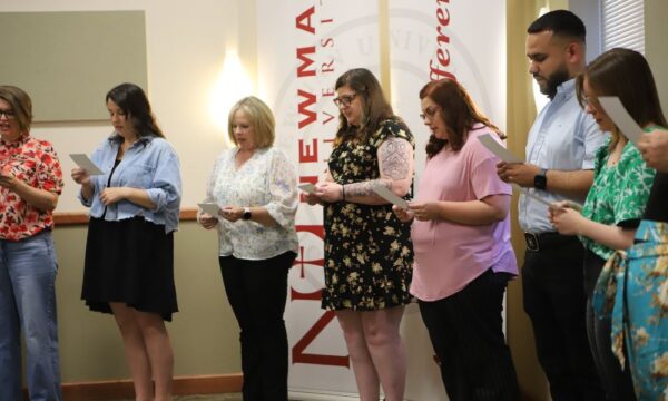 Master of Social Work graduates read social work oath.