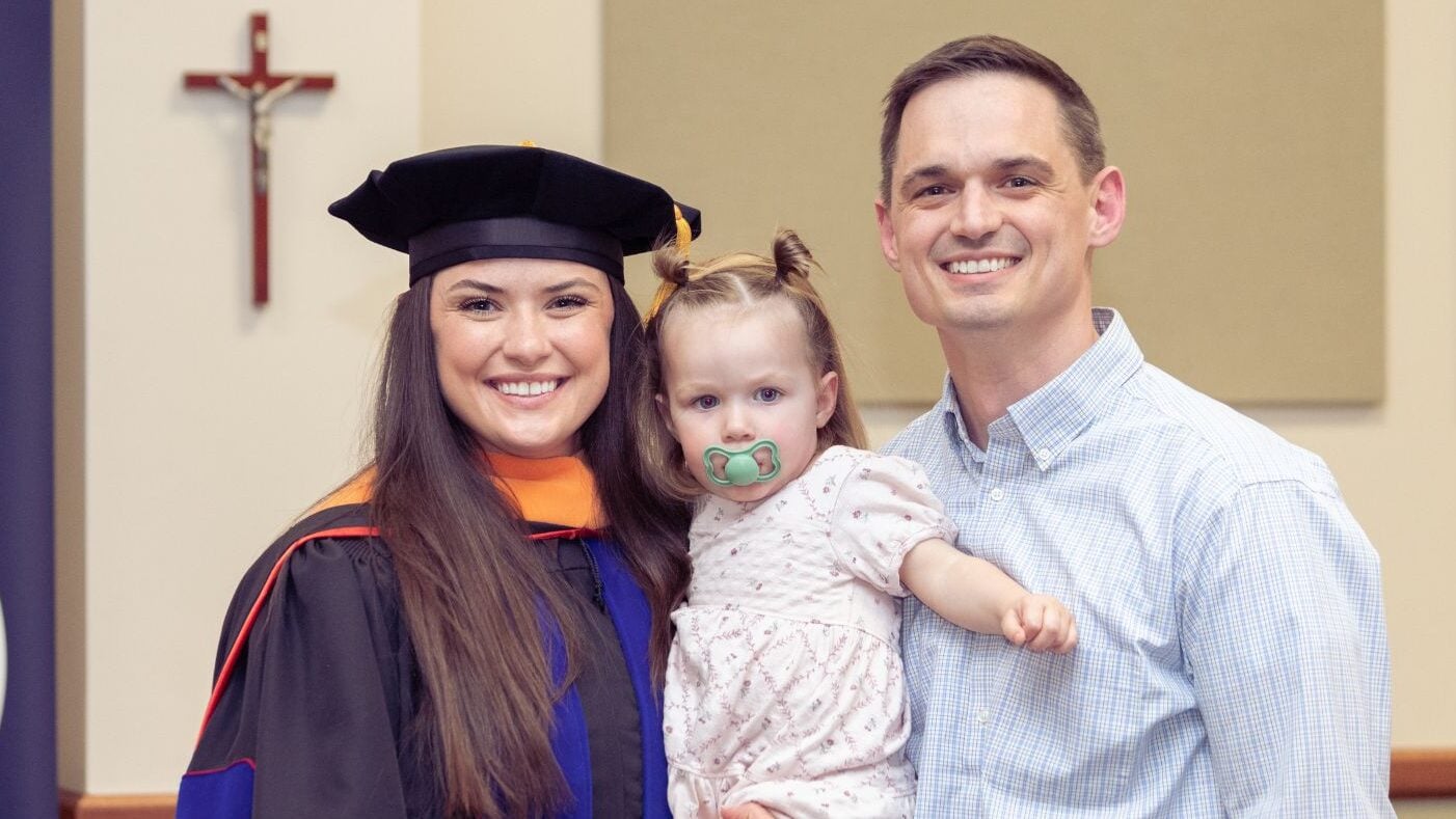 A DNAP graduate with her husband and daughter.